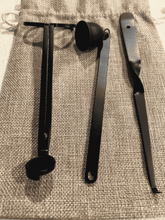 Load image into Gallery viewer, Black candle care kit with wick trimmer, snuffer, and dipper displayed on a hessian storage bag.