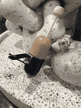 Load image into Gallery viewer, Black glass and wooden car diffuser placed on a textured stone background, highlighting its stylish natural look.