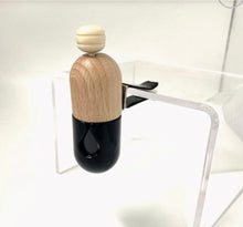 Load image into Gallery viewer, Black glass and wooden car vent diffuser attached to a clear surface, showing minimalist modern design.