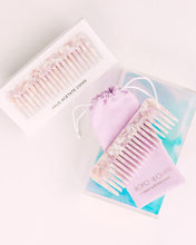 Load image into Gallery viewer, Bopo Women Halo Hair Drops Gift Set with lilac comb, gold foil pouch, and nourishing oil displayed on a pastel background.
