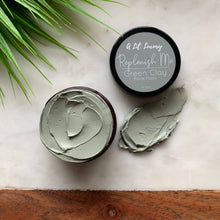 Load image into Gallery viewer, French green clay face mask jar on wooden board, nourishing skincare with aloe vera and shea butter.