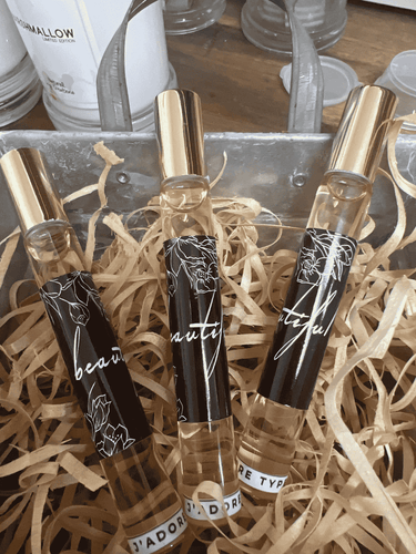 Beautiful J’Adore type perfume roller with elegant black glass bottle and gold lid, 10ml size for long-lasting fragrance.