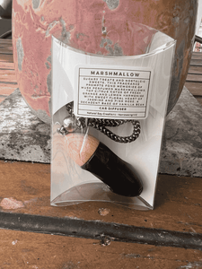 Black bullet car diffuser with wooden cap shown in retail packaging by Natural Soy Creations.