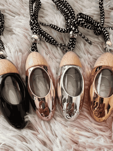 Set of four bullet car diffusers with wood tops and cords, including the black diffuser option.