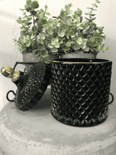 Load image into Gallery viewer, Black geo candle with gold lid shown beside plant, elegant luxury home gift design.
