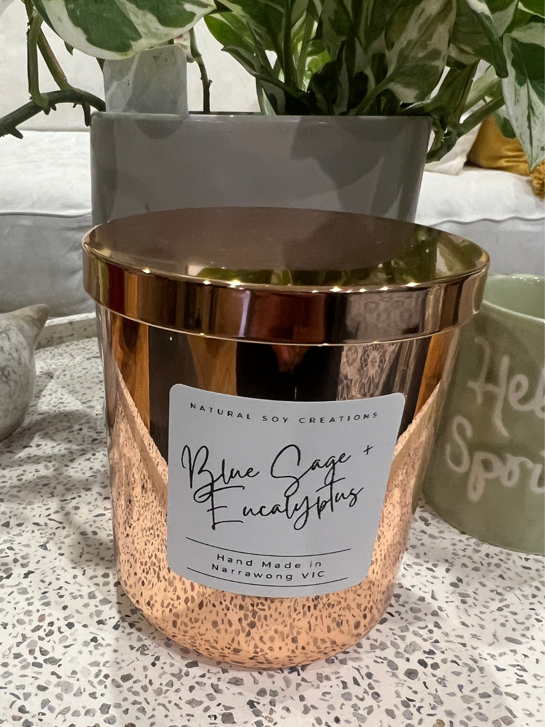 Blue Sage & Eucalyptus soy candle in a reflective rose gold jar with matching lid, handmade by Natural Soy Creations.