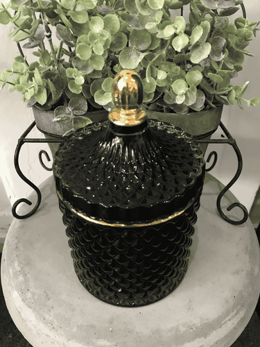 Deluxe black geo candle with gold trim, 500ml soy wax, displayed on stone table with greenery.
