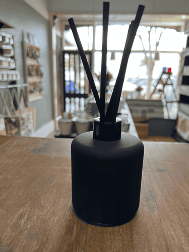 Black matte reed diffuser with black reeds for modern home décor.