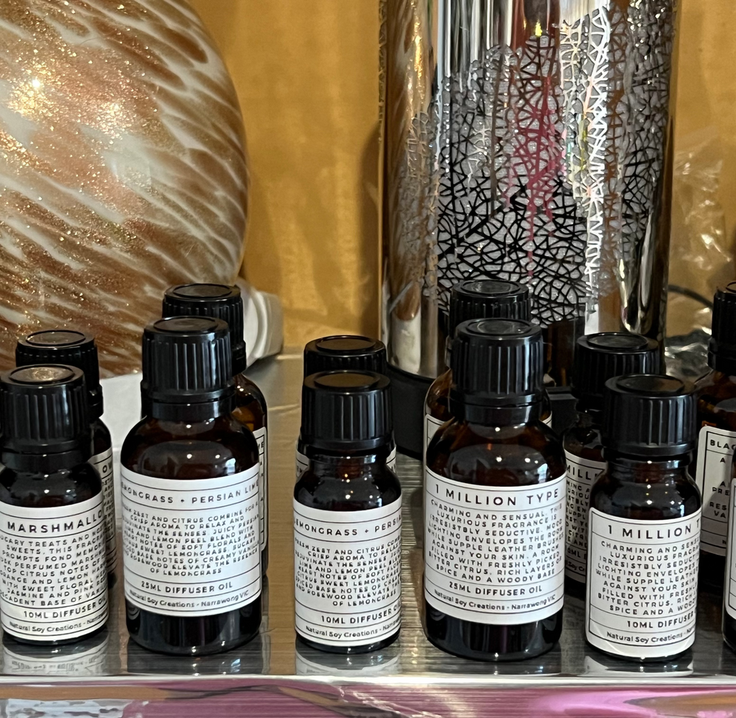 A collection of 10ml diffuser fragrance oil bottles arranged together on a reflective surface, designed for ultrasonic diffusers and car diffuser pads.