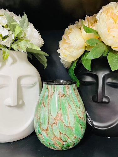 Emerald green glass electric wax melt warmer displayed beside flowers, elegant home fragrance and décor piece.