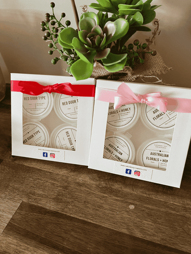Gift boxed soy melt shot pots in assorted fragrances including Red Door Type and Australian Florals + Honey, packaged with ribbon detail.