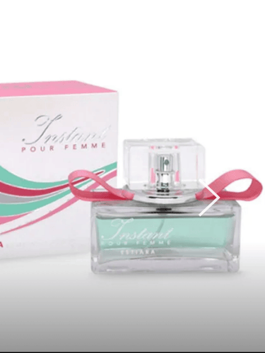 Instant Pour Femme Eau de Parfum by Estiara, light green fragrance in a clear glass bottle with pink ribbon detail, displayed with matching pink and green box.