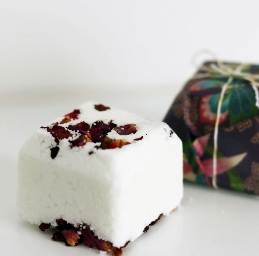 Natural Soy Creations Magnolia and Rose bath bomb with organic rose petals, displayed with floral wrapping.