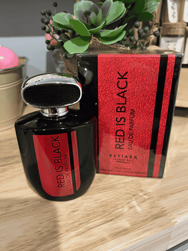 Red is Black Eau de Parfum by Estiara, black bottle with red label, displayed with matching packaging on a wooden surface