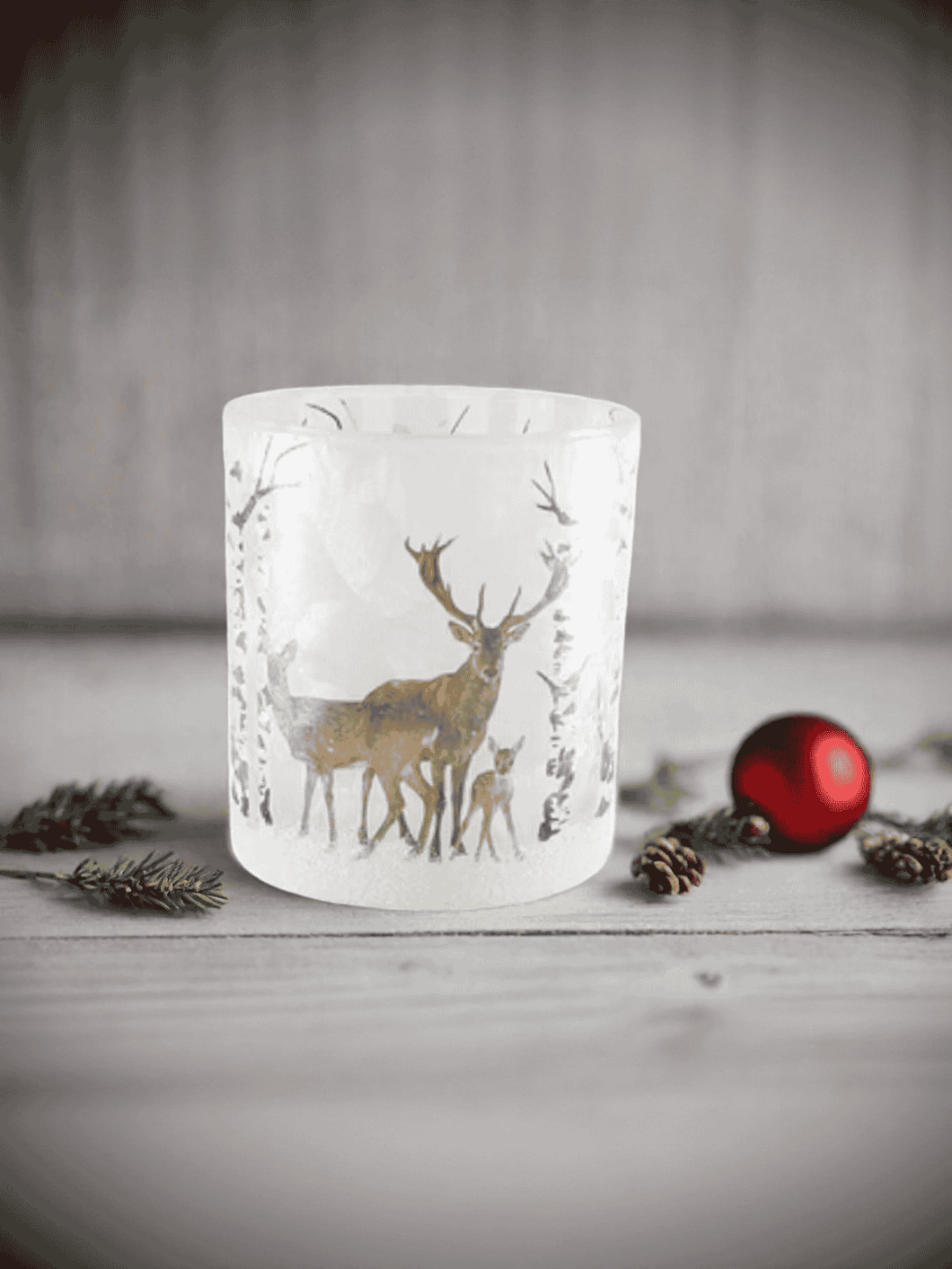 Scandi Snow Deer Soy Candle in frosted glass jar with gold deer design and festive décor.