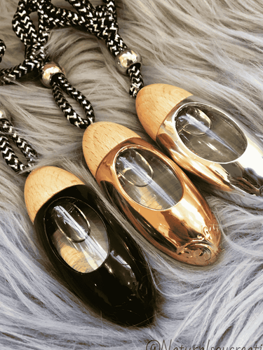 Set of three bullet car diffusers with wood tops and hanging cords in assorted metallic finishes, including silver.