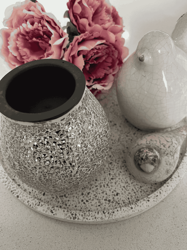 Natural Soy Creations Silver Mosaic Electric Heat Plate Wax Warmer displayed on a tray with pink flowers.