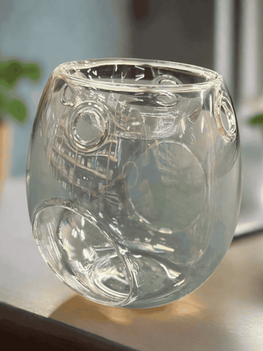 Clear glass tea light melt warmer with circular patterns, designed for melting wax melts with a candle underneath.