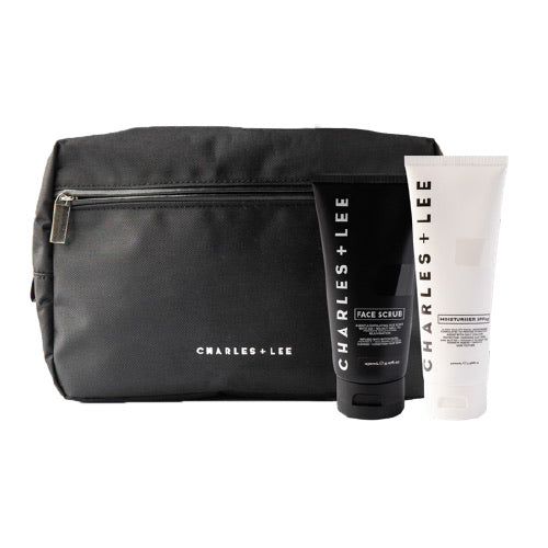 A facial cleansing kit containing a black face scrub and a white moisturizer bottle, both with the brand name 'charles & lee'.