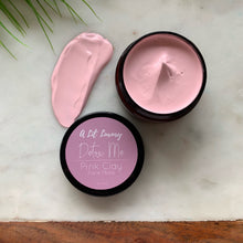 Load image into Gallery viewer, Open jars of pink and green clay masks on wooden surface, soothing natural skincare blend.
